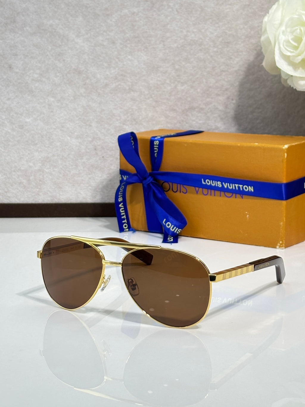 Gold-tone cat-eye sunglasses with dark brown lenses and slim metal temples
