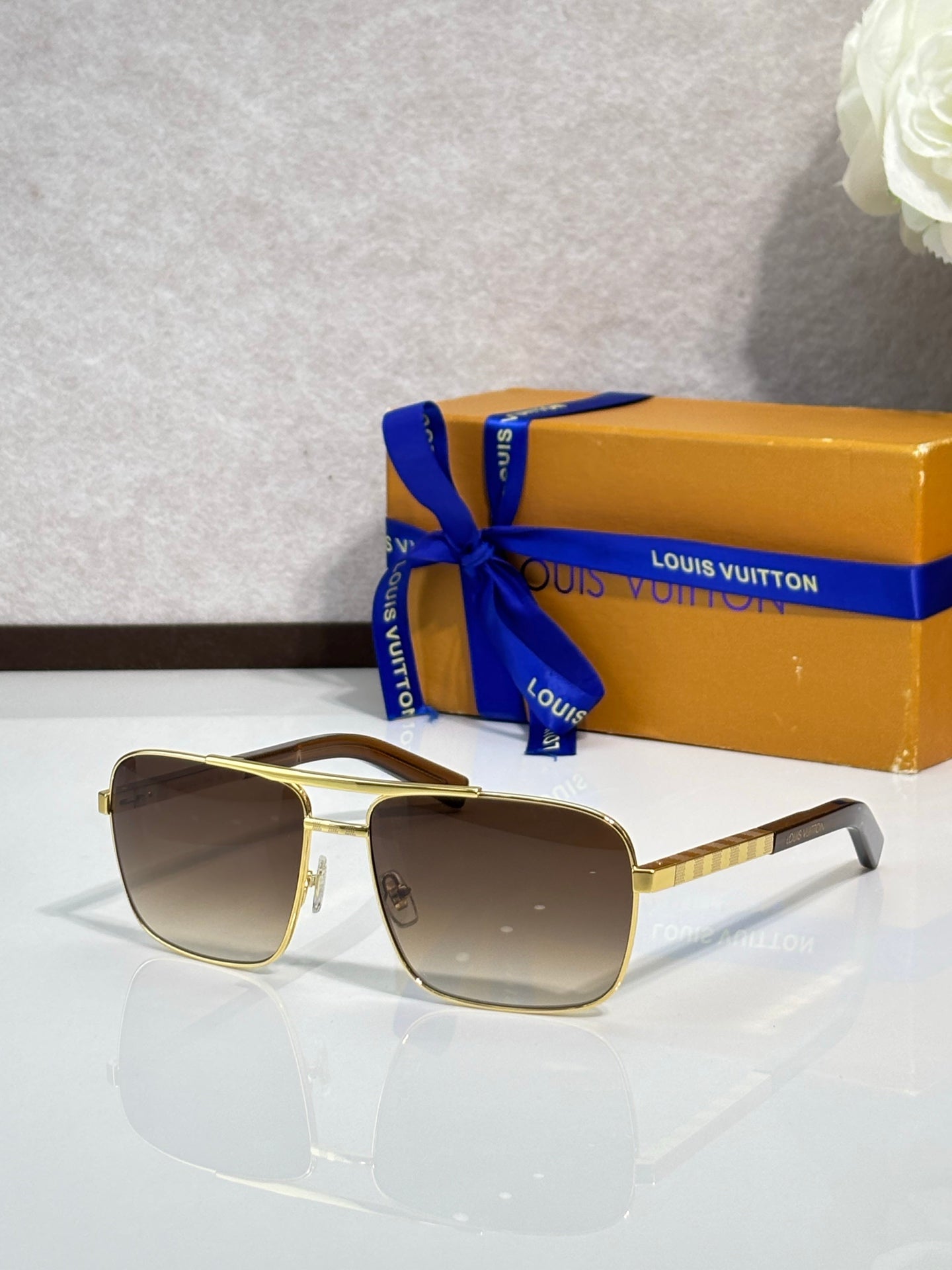 Louis Vuitton gold square sunglasses with dark gray lenses and slim arms