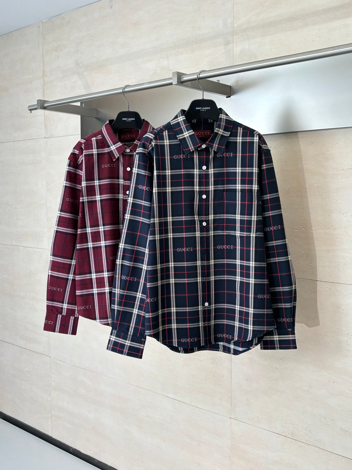 Gucci long-sleeve plaid shirt pair on hangers: dark navy and burgundy check button shirts
