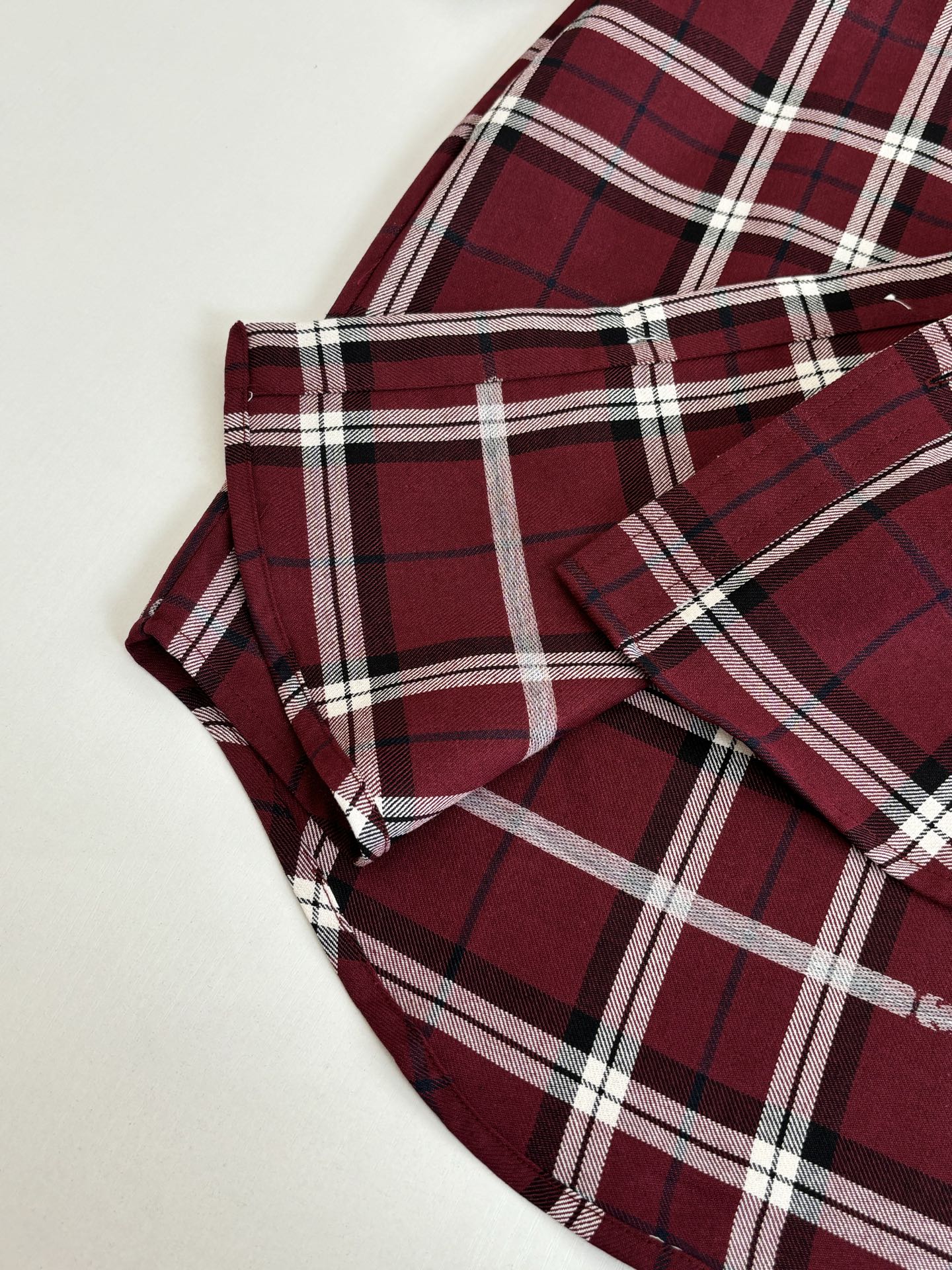 Gucci long-sleeve plaid shirt, dark red/white checks, folded with visible collar and cuffs