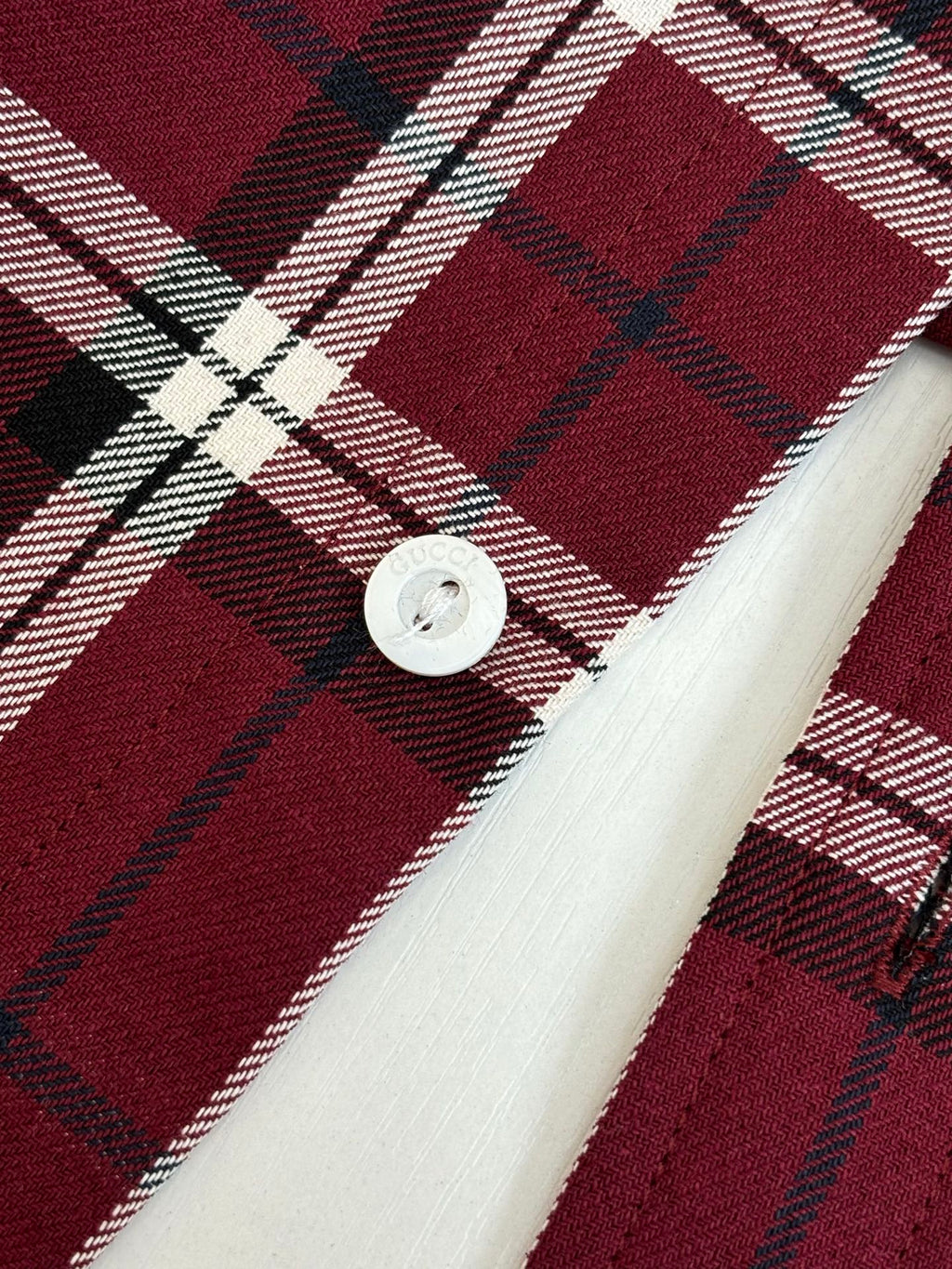 Gucci plaid shirt cuff detail, dark red tartan with white lines, white button