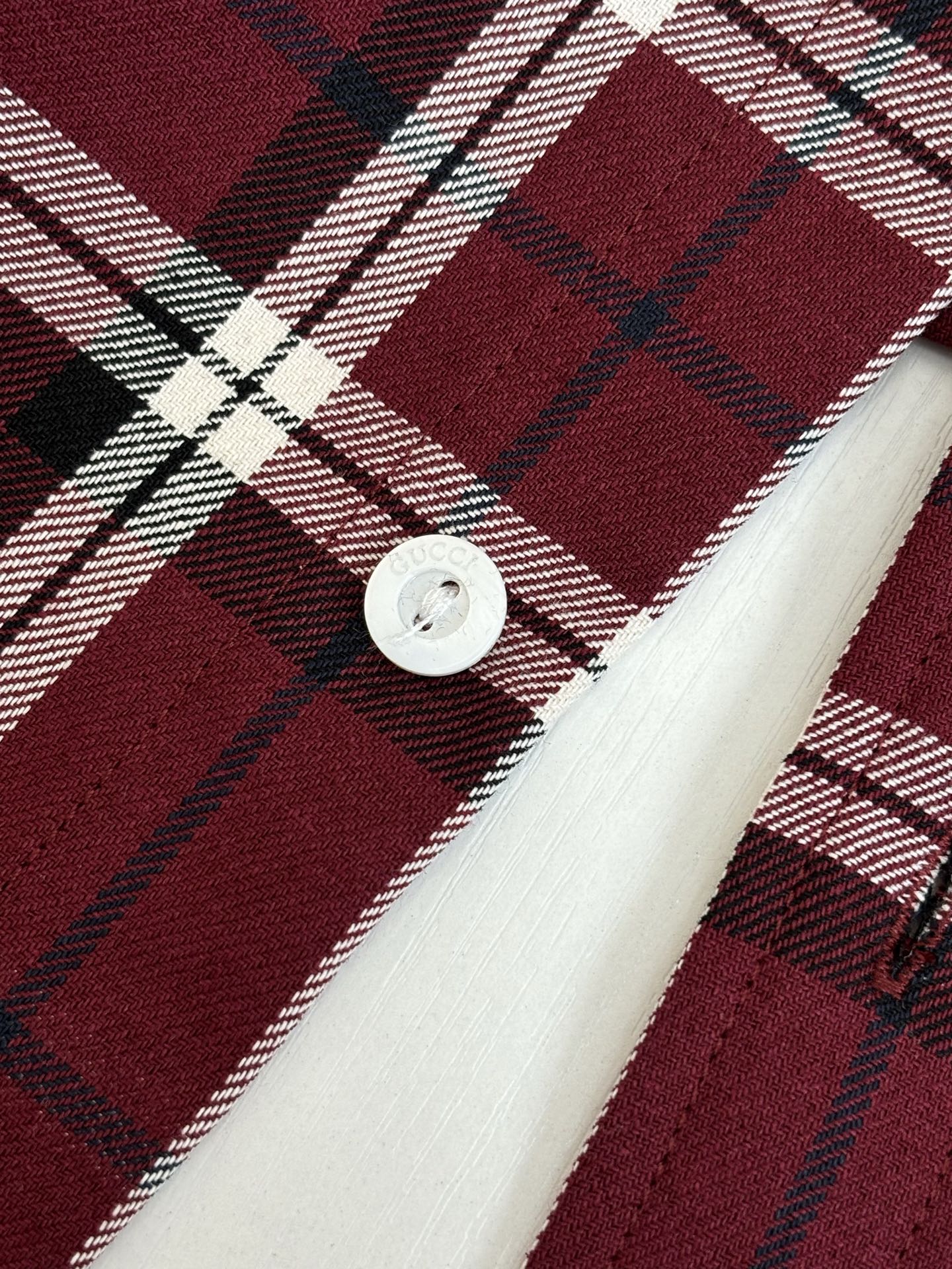 Gucci plaid shirt cuff detail, dark red tartan with white lines, white button