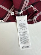 Red plaid long-sleeve shirt with white care label and collar