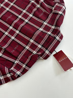 Red plaid long-sleeve shirt with white trim and brand tag detail