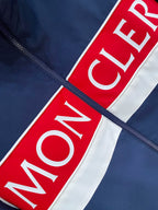 Red and white logo stripe on navy jacket
