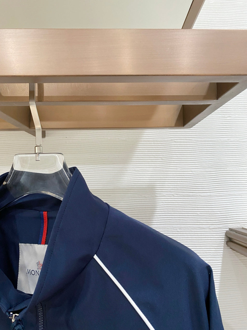 Dark navy jacket with white contrast piping and ribbed cuffs