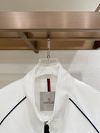White hooded long jacket with central logo patch and navy piping