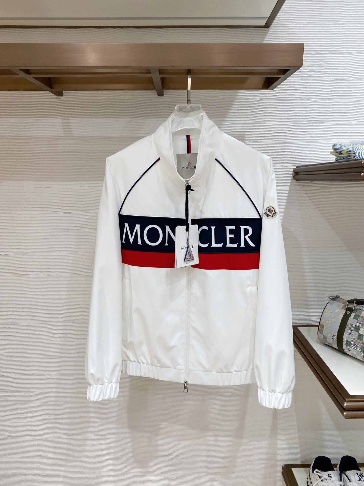 White Moncler long jacket with navy trim and red accent stripe