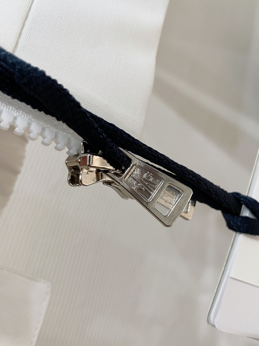 Long jacket snap closure with metal pull on dark drawcord