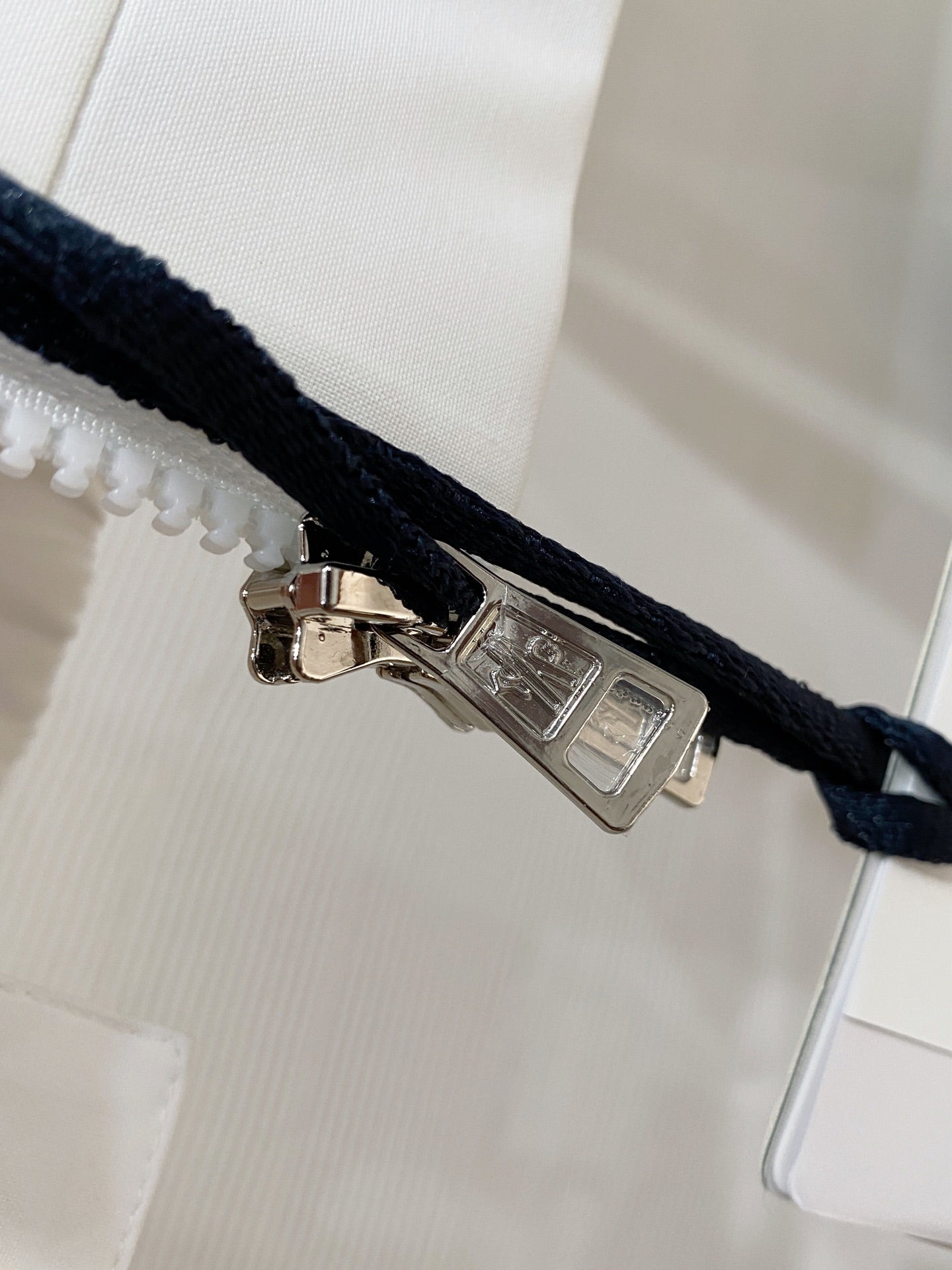 Long jacket snap closure with metal pull on dark drawcord
