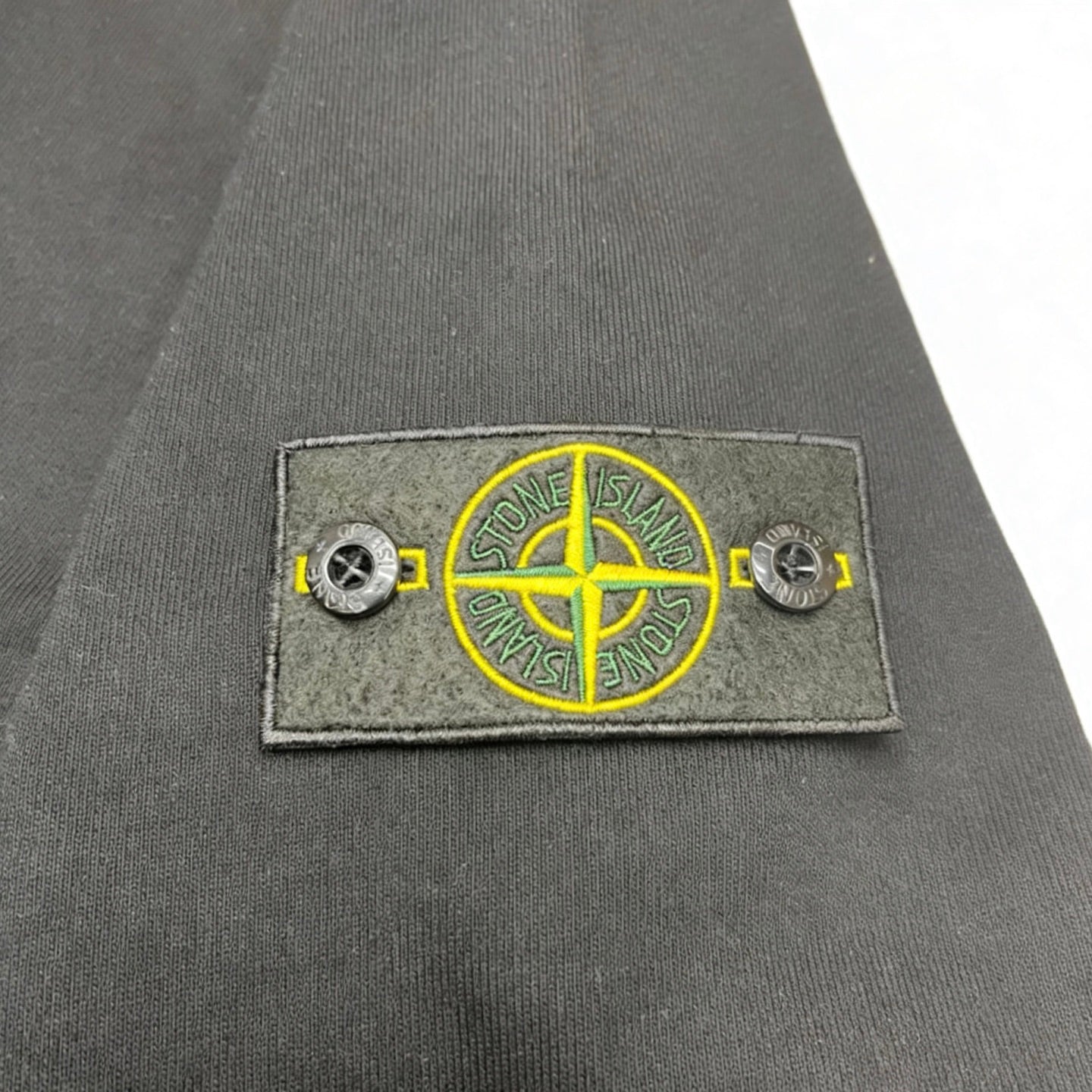 Stone Island chest logo patch with yellow compass emblem and side buttons