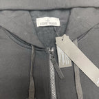 Stone Island zip-up hoodie neckline label and front zipper placket with tags