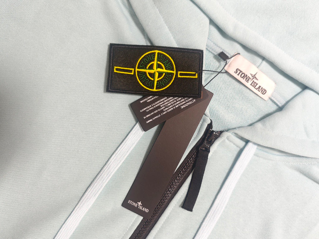 Stone Island light blue zip-up hoodie neckline with drawstrings and tags