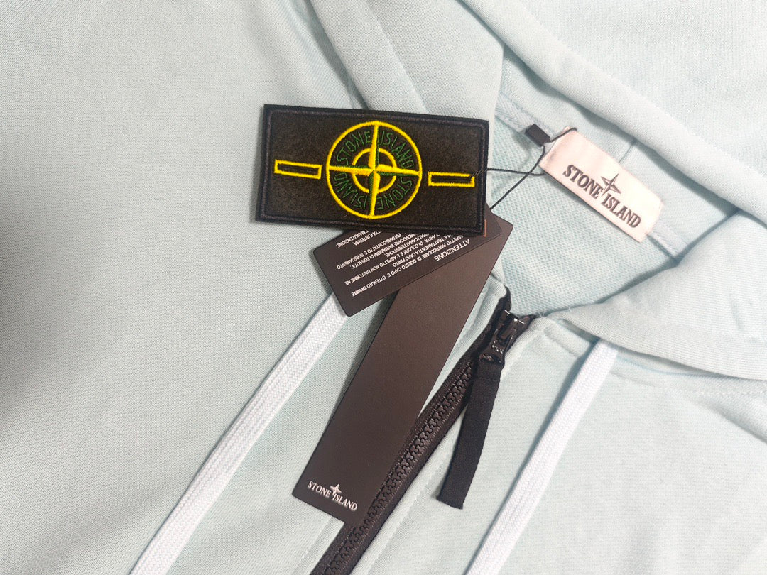 Stone Island light blue zip-up hoodie neckline with drawstrings and tags