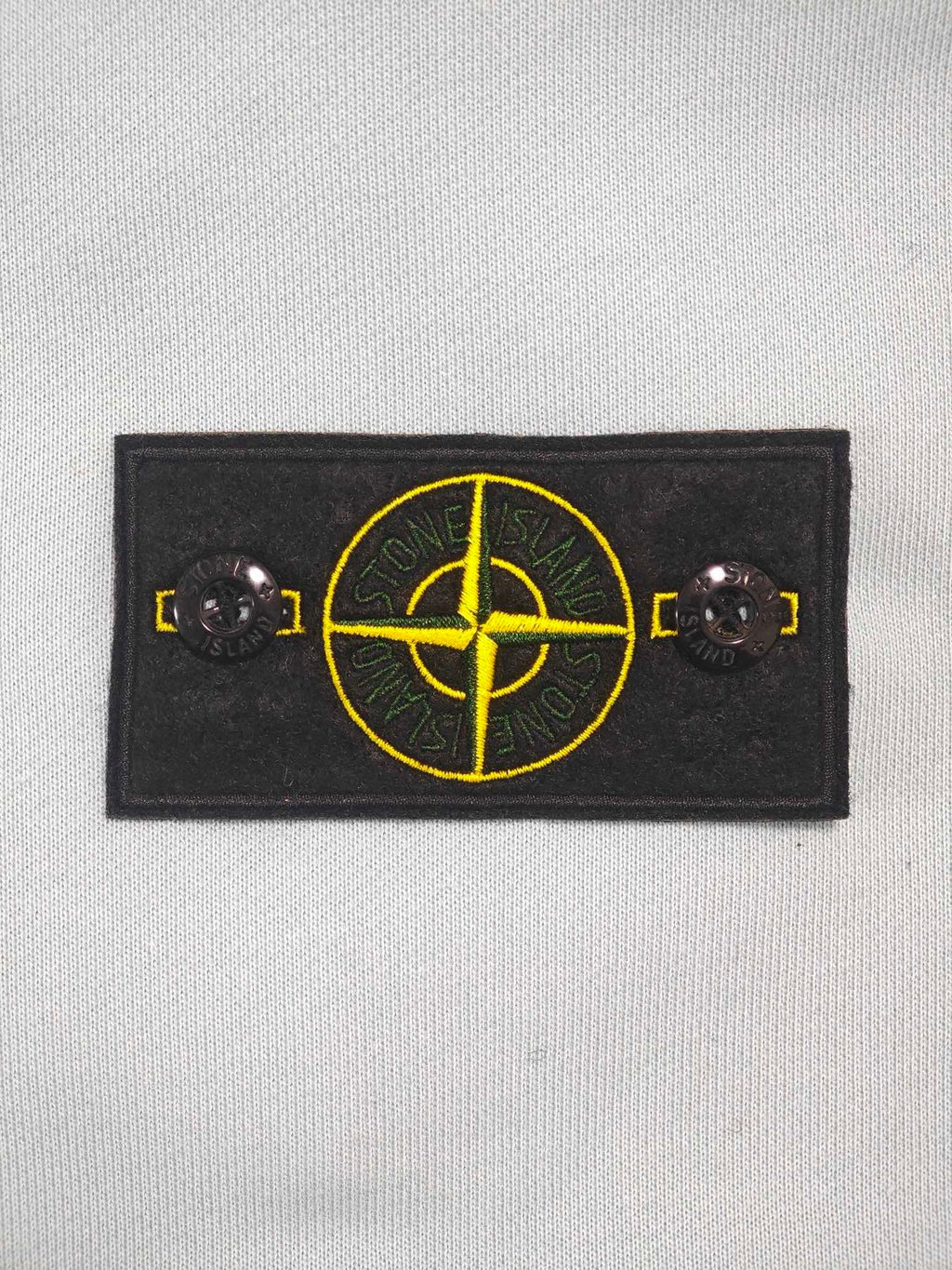 Stone Island light blue zip-up hoodie chest logo patch with yellow emblem