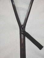 Stone Island light blue zip-up hoodie close-up of black zipper and pull tab