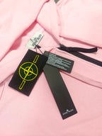 Pink hoodie neckline with black and white tags and yellow Stone Island emblem