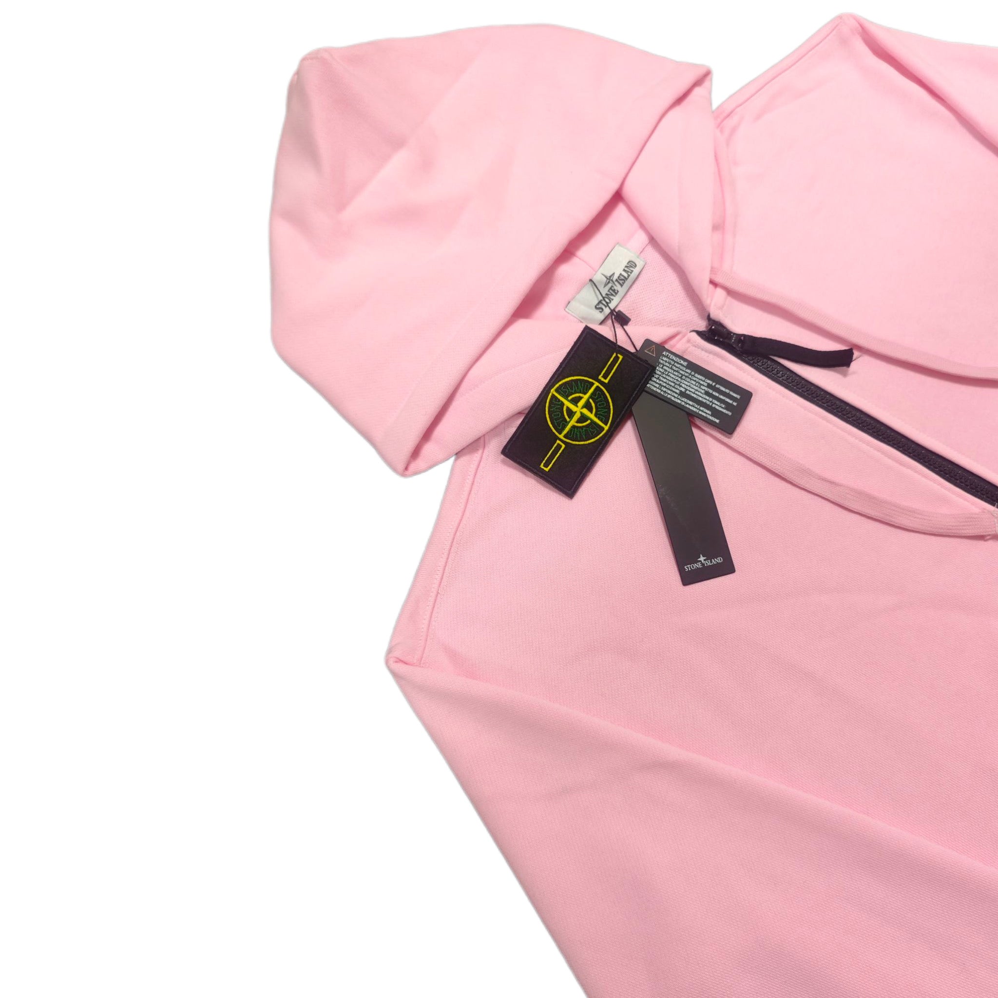 Pink hoodie chest detail with black tag and yellow Stone Island emblem
