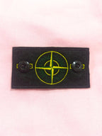 Pink hoodie chest logo patch with yellow Stone Island emblem and snap buttons