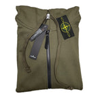 Olive hooded zip-up hoodie close-up with chest badge and drawstrings