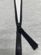 Stone Island hoodie zipper pull and black zip tape on light gray marl knit.