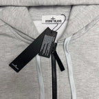 Stone Island hooded zip top, light gray marl with Stone Island logo at collar.