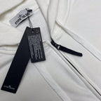 White Stone Island zip hoodie with hang tags and drawcord details