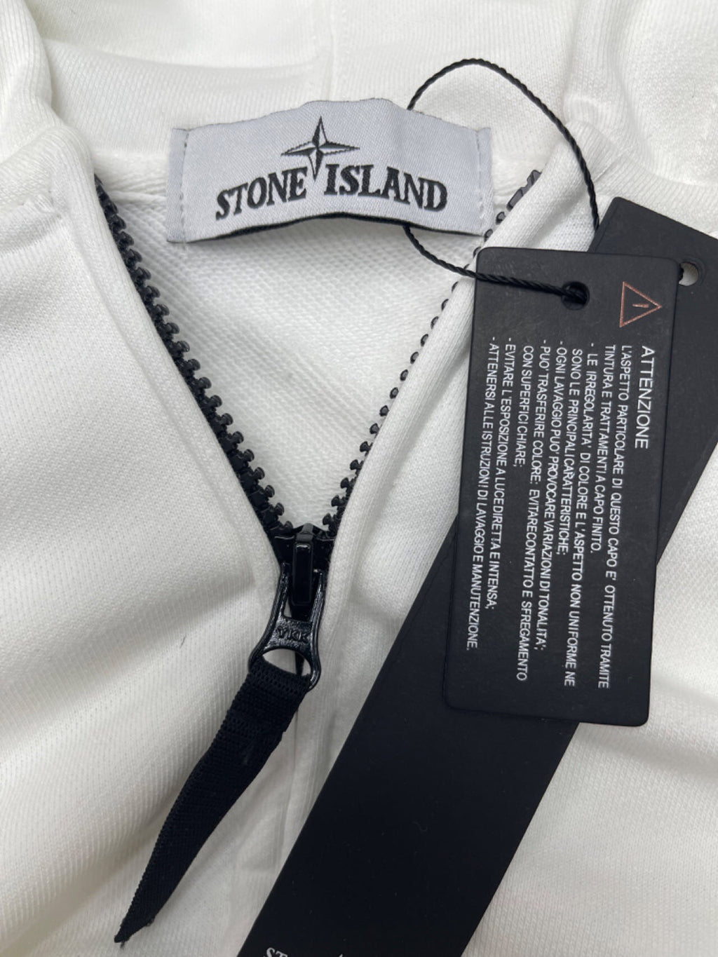 White Stone Island jacket with black zip and branded inner label