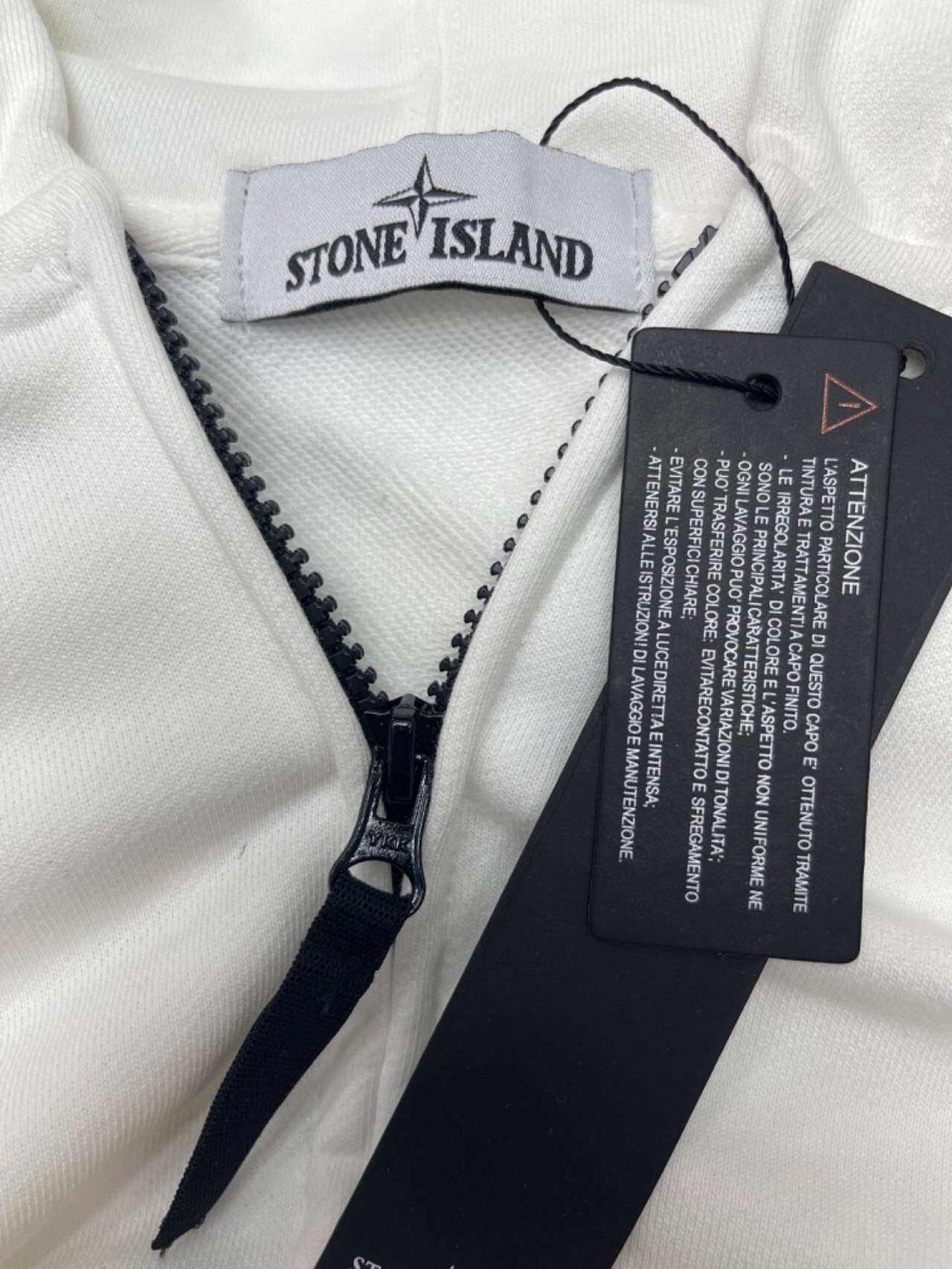White Stone Island jacket with black zip and branded inner label