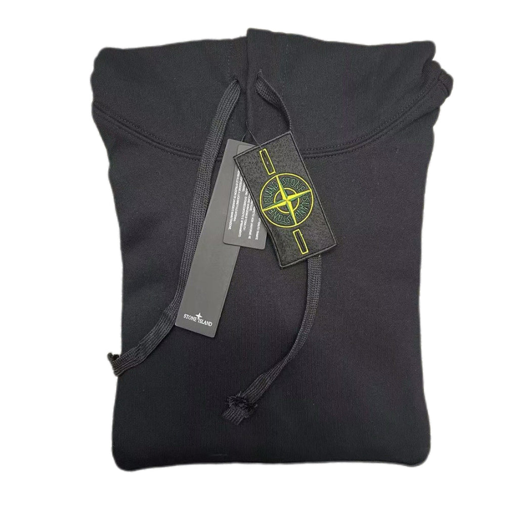 Dark hooded sweatshirt front view with ribbed cuffs and hanging care tags