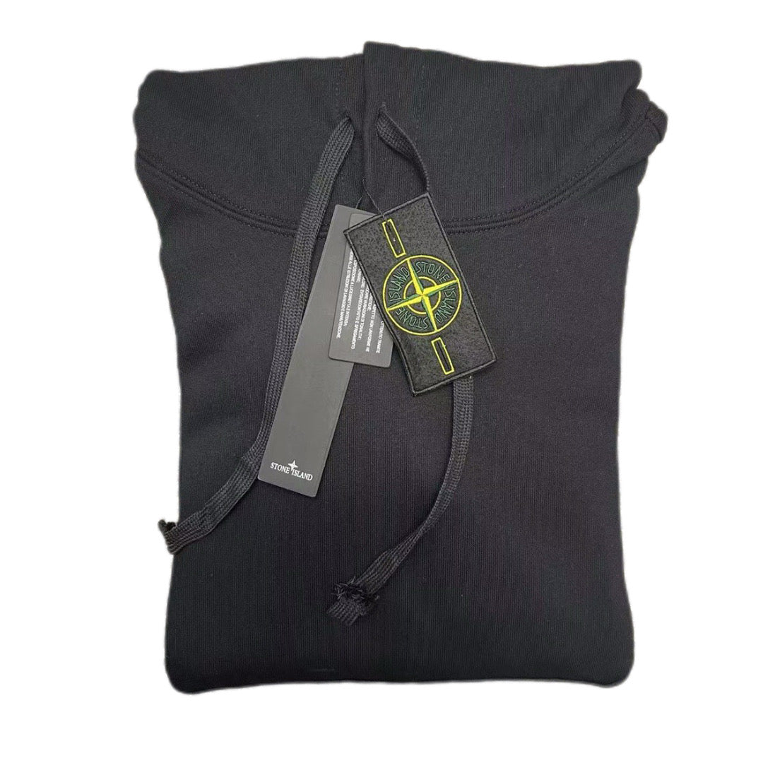 Dark hooded sweatshirt front view with ribbed cuffs and hanging care tags