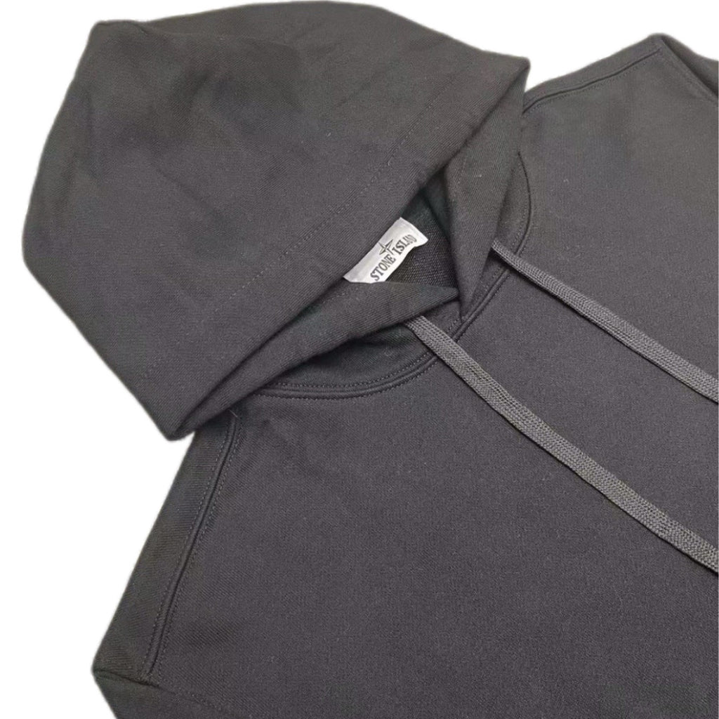 Dark hooded sweatshirt hood and sleeve close-up with drawstring cord