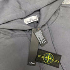 Gray hoodie with hood label and logo patch on chest