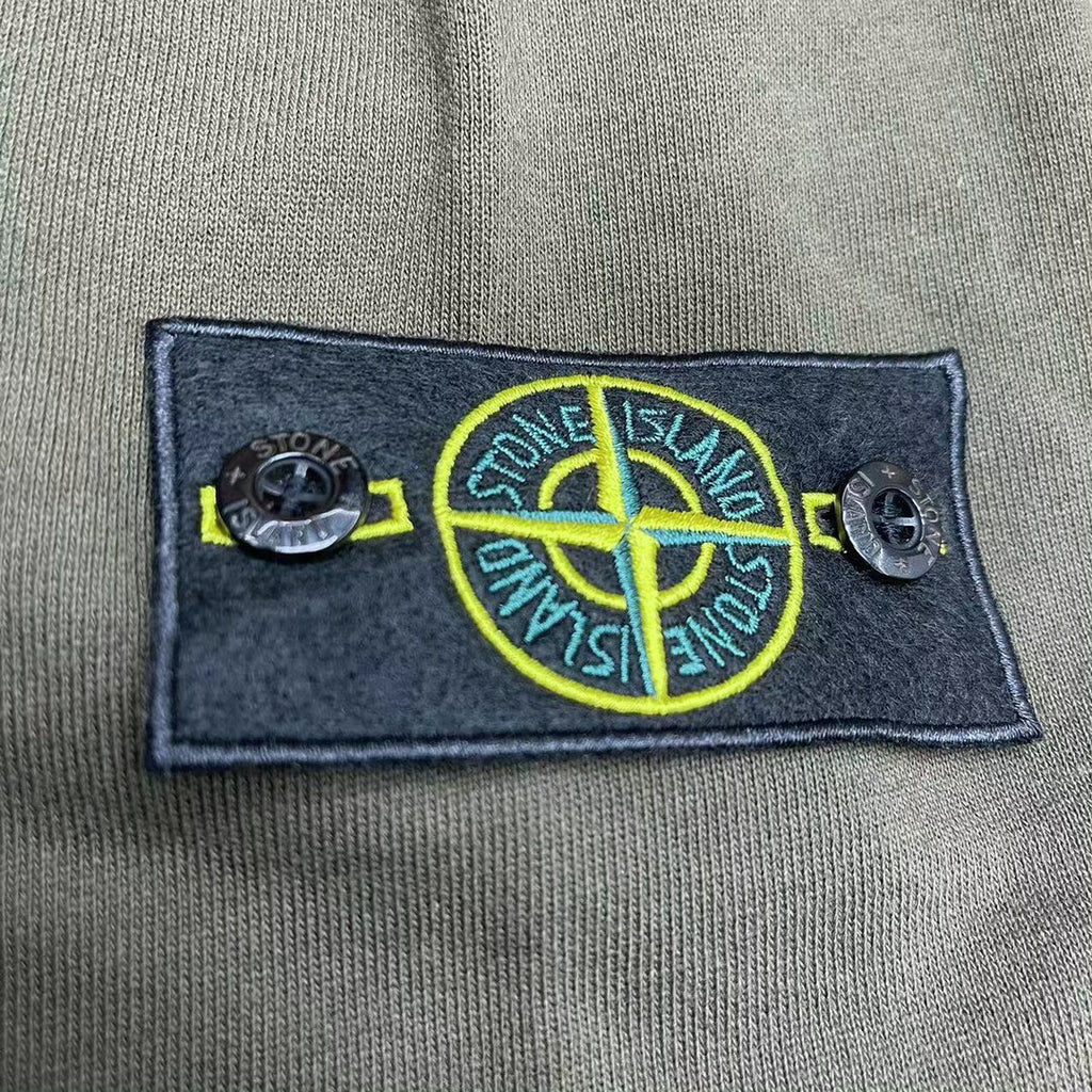 Stone Island logo patch on olive hoodie chest