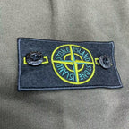 Stone Island logo patch on olive hoodie chest