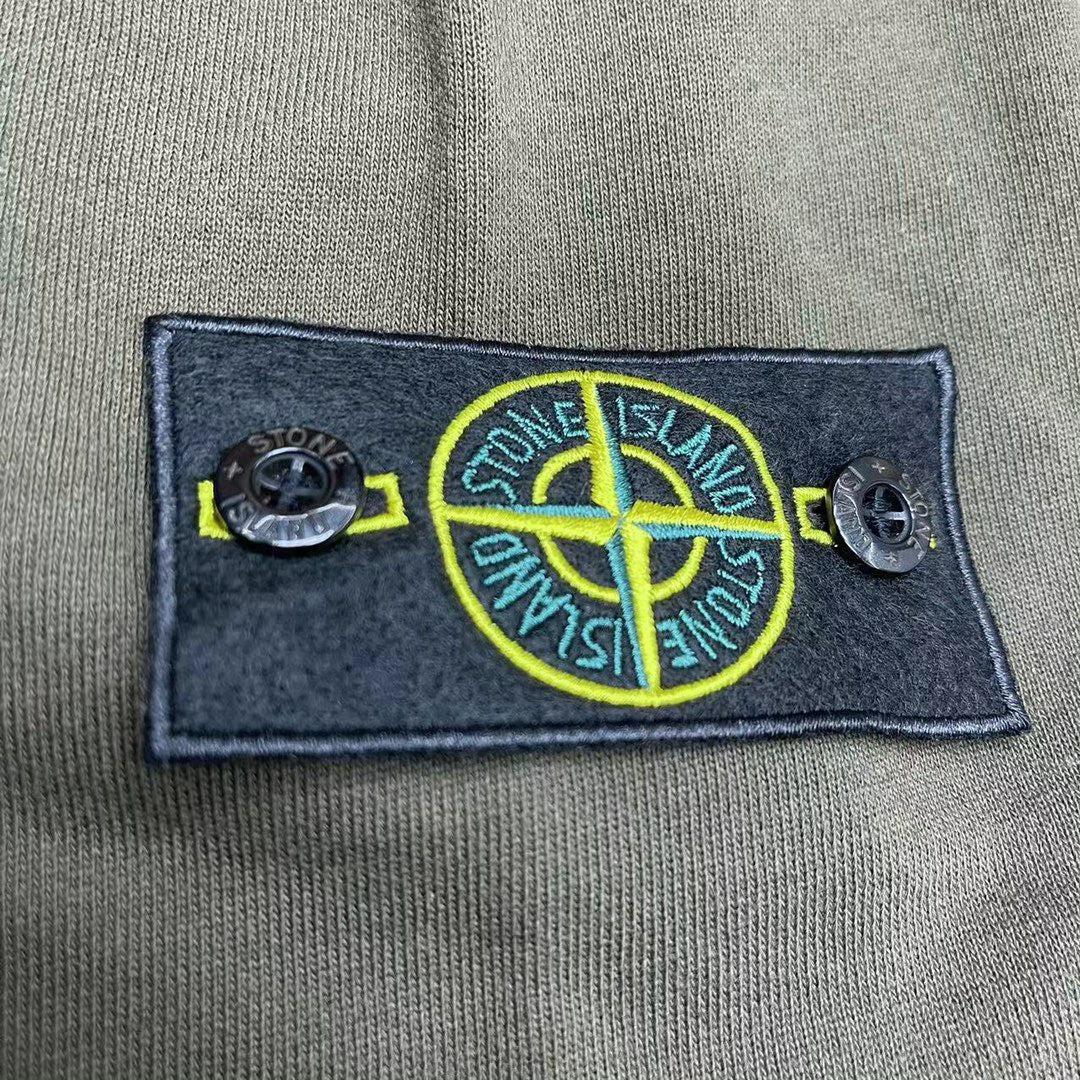 Stone Island logo patch on olive hoodie chest