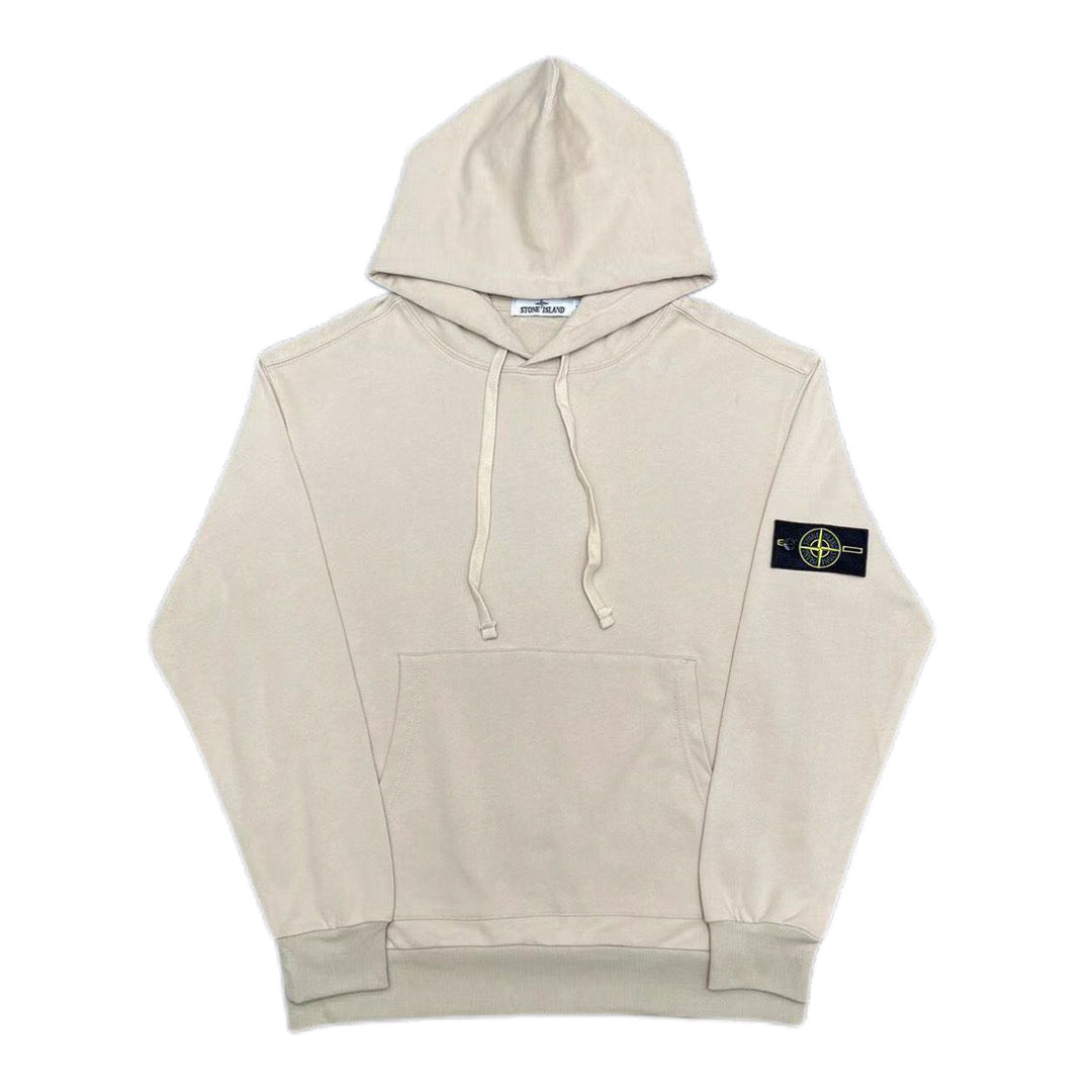 Cream pullover hoodie with drawstring hood, pouch pocket, and left sleeve badge