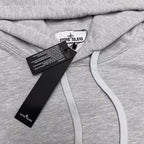Stone Island gray hoodie close-up of chest tags and light drawstring