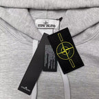 Stone Island gray hoodie close-up of yellow logo patch and drawstring