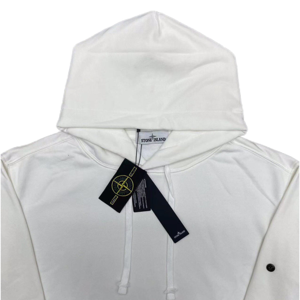 White Stone Island hoodie hood with front drawstrings and logo patch, tags attached