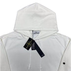 White Stone Island hoodie hood with front drawstrings and logo patch, tags attached