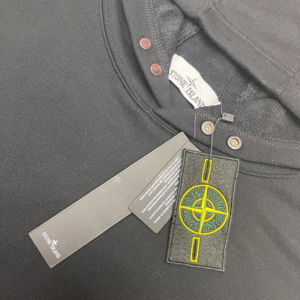 Gray hooded sweatshirt close-up of neck label and snap-button placket