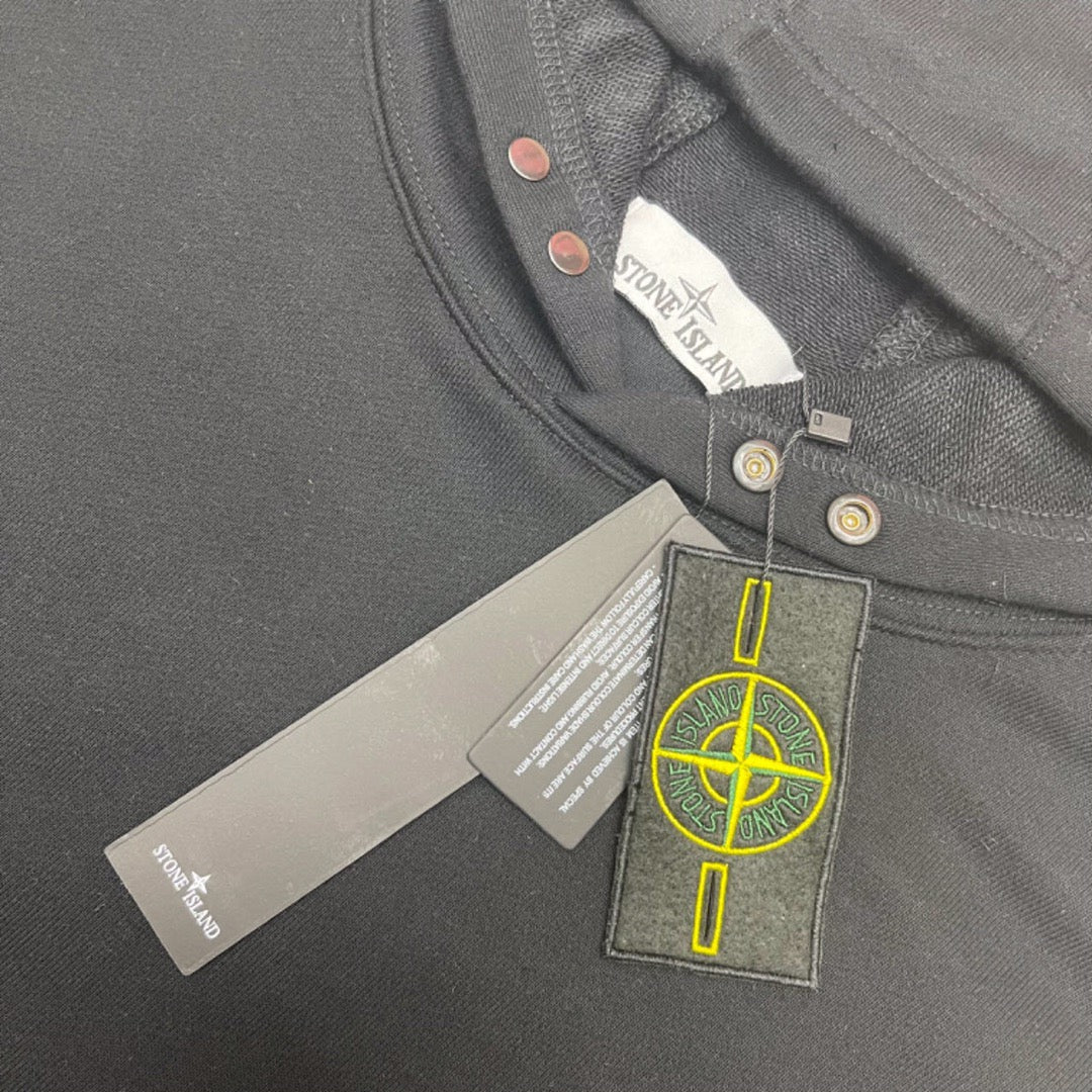 Gray hooded sweatshirt close-up of neck label and snap-button placket