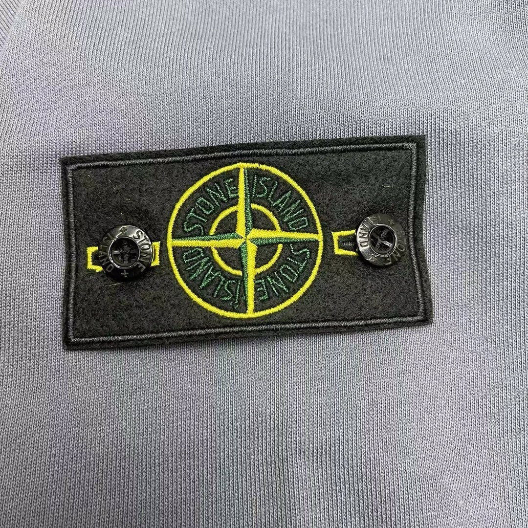 Stone Island embroidered logo patch in yellow on black fabric