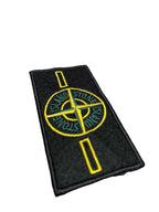 Stone Island logo embroidered patch with yellow emblem on black backing fabric