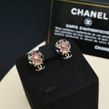 Chanel floral stud earrings with pink stones and gold-tone CC logo