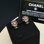 Chanel floral stud earrings with pink stones and gold-tone CC logo