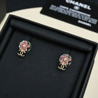 Chanel floral stud earrings with pink enamel flower and gold-tone CC logo