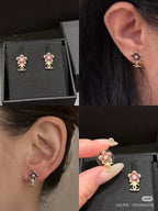 Chanel floral stud earrings on ear and close-up, pink stones, gold-tone CC