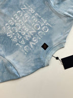 Light blue tie-dye sweatshirt with arched glitter logo text on chest